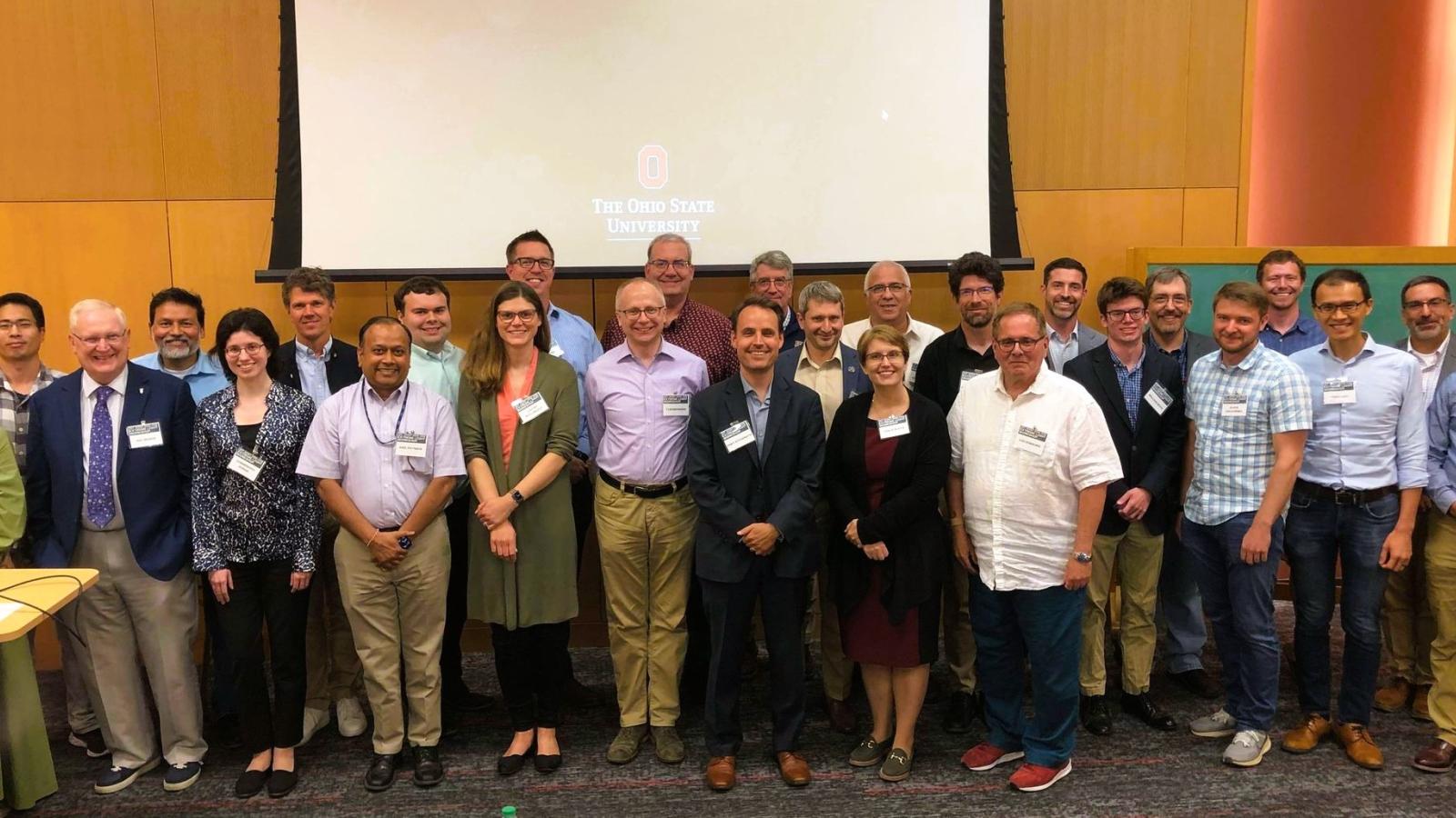 The picture shows a group photo of participants at the workshop.